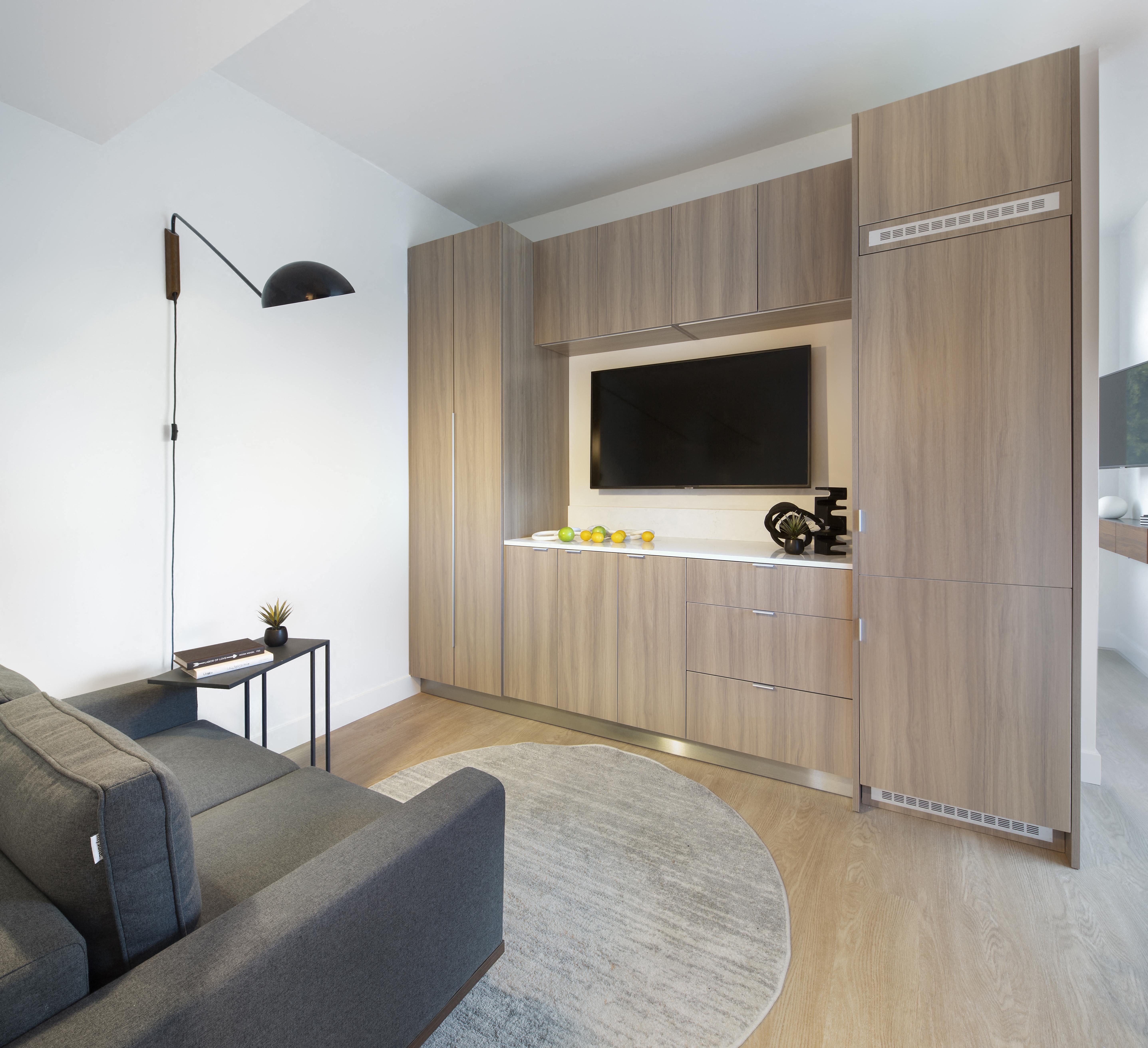 a modern kitchen with stainless steel appliances and wooden cabinets